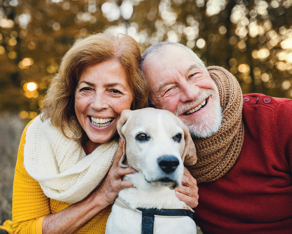 happy couple with family dog